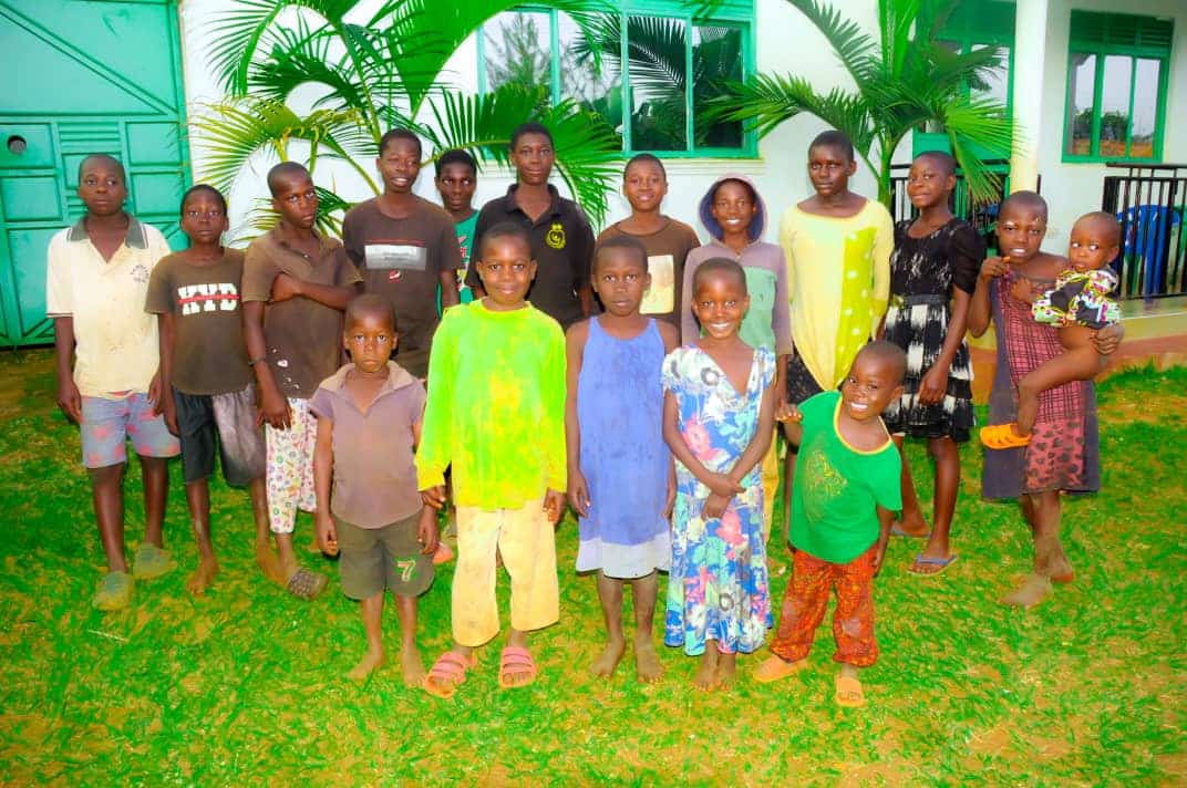 Happy children at Starlight Orphanage standing together outside the facility